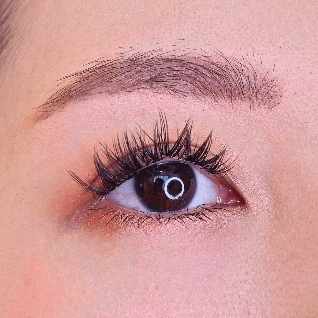 Close up picture of a beautiful female model's right eye wearing HanaDolly's FLIRTY lash style to show the DIY lashes when worn - flirty romantic lashes