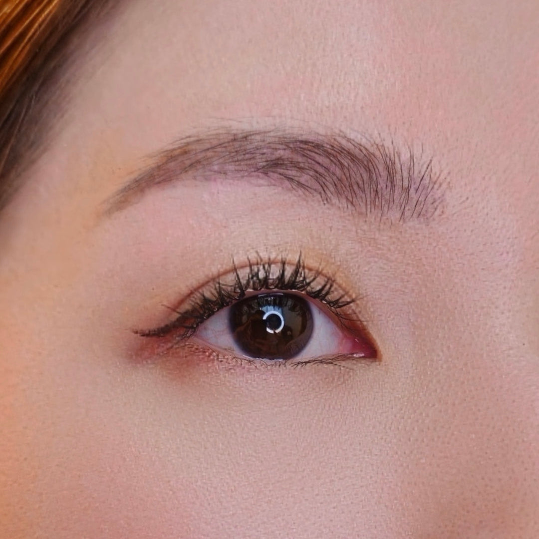 Close up video of a female model's right eye repeatedly blinking and wearing HanaDolly's BARE lash style to showcase the DIY lashes in action