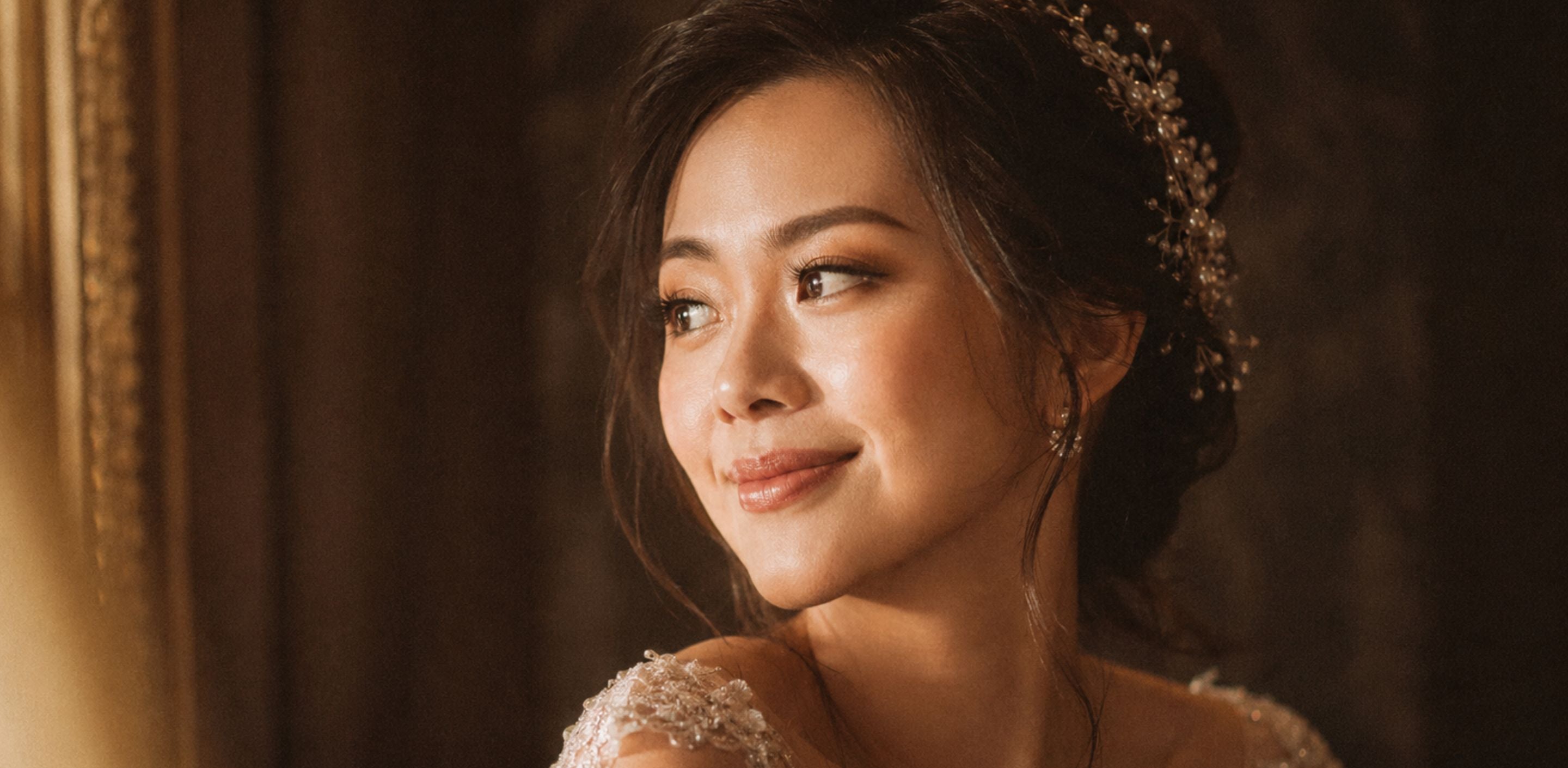 Singaporean bride with soft natural glam bridal makeup, dewy skin, fluttery lashes, elegant updo and warm golden lighting for a bridal makeup Singapore guide.