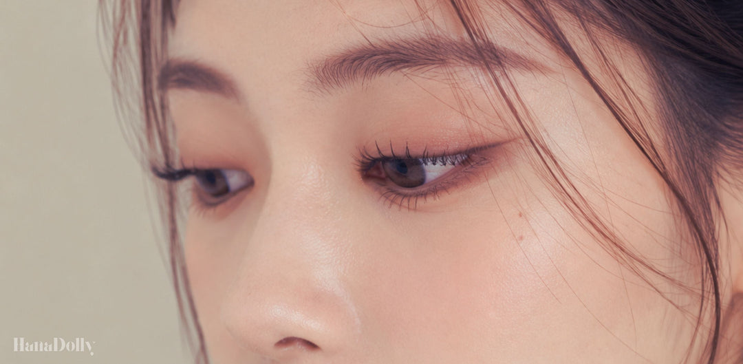 Close-up of soft wispy Korean-style lashes on an Asian woman, showing a natural fluttery lash look created with lightweight DIY lash clusters.