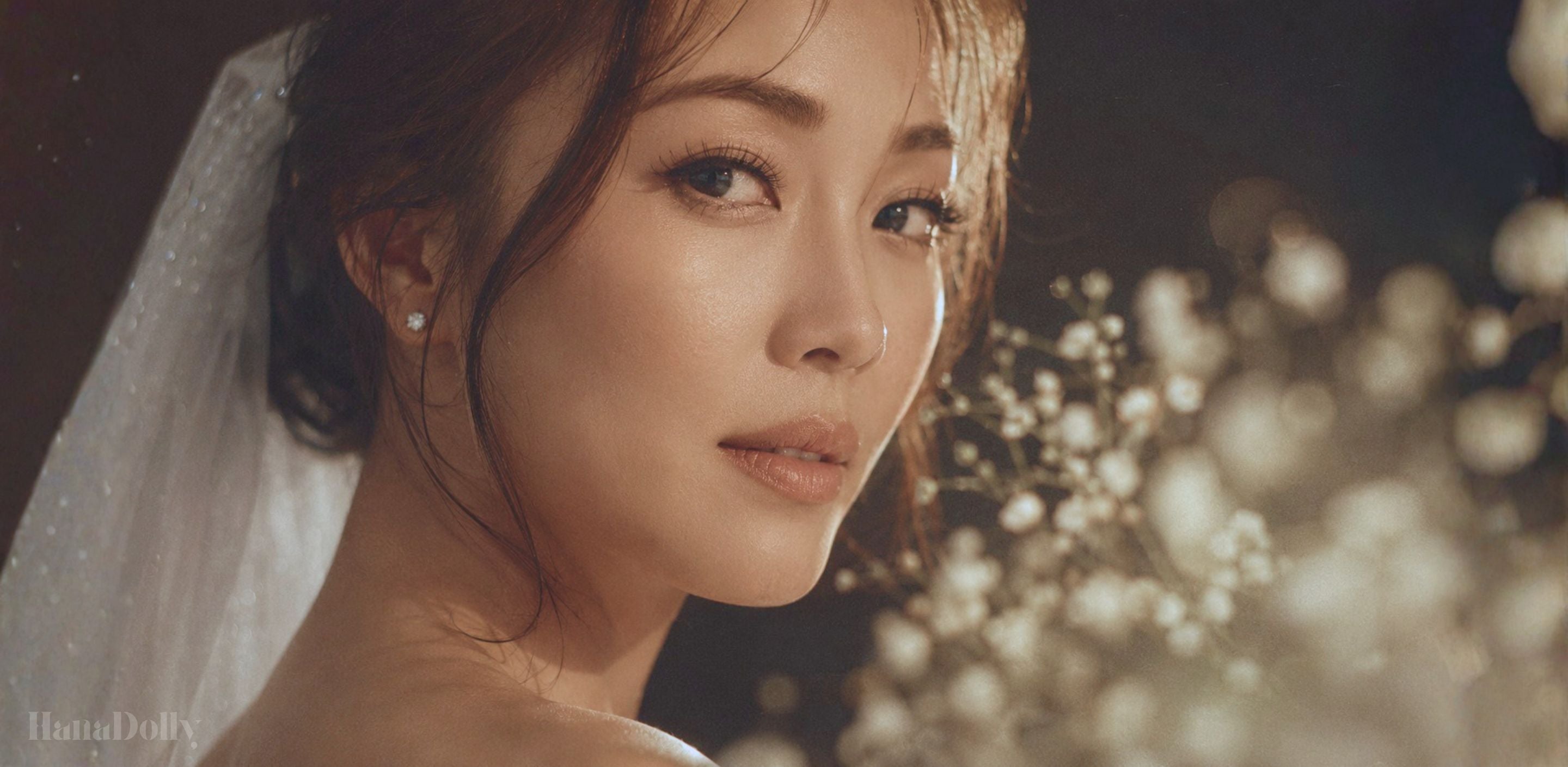 Singapore bride with soft natural makeup, delicate wispy wedding lashes, and a white veil in warm golden light for a romantic bridal lash look.