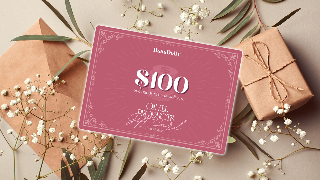 An image depicting a $100 Hanadolly beauty gift card with decorative beautiful background. The gift card is applicable for all products on HanaDolly's online store.