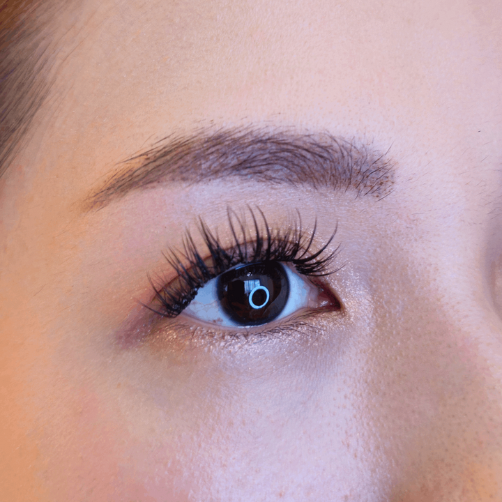 Close up picture of a beautiful female model's right eye wearing HanaDolly's BABYDOLL lash style to show the DIY lashes when worn - Babydoll glam up lash look