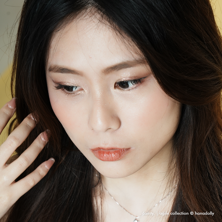 Beautiful asian female model looking downwards to reveal lovely lashes, she is wearing the DAINTY lash style from the Agile Lash Collection by HanaDolly