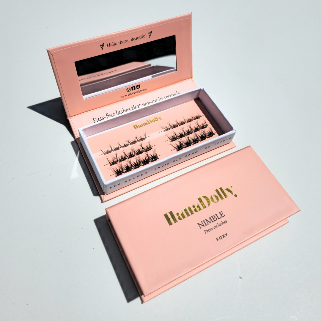 HanaDolly's FOXY self-adhesive lashes displayed with display open box on top and closed box below