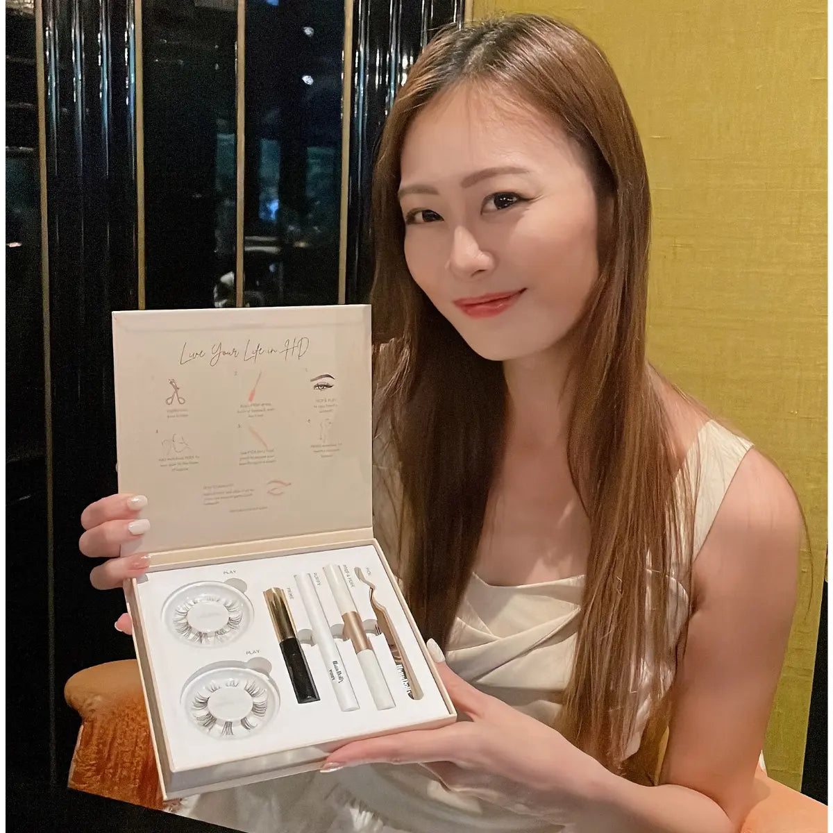 Smiling woman posing with HanaDolly DIY press-on lash kit