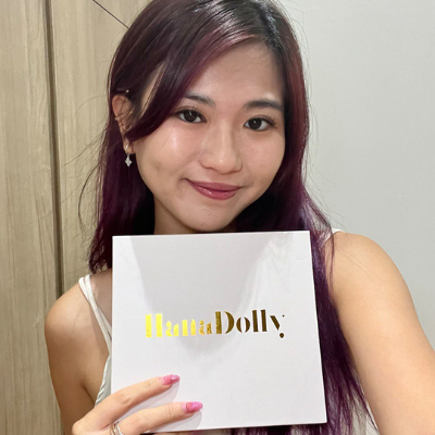 Female customer smiling while holding HanaDolly DIY lash kit