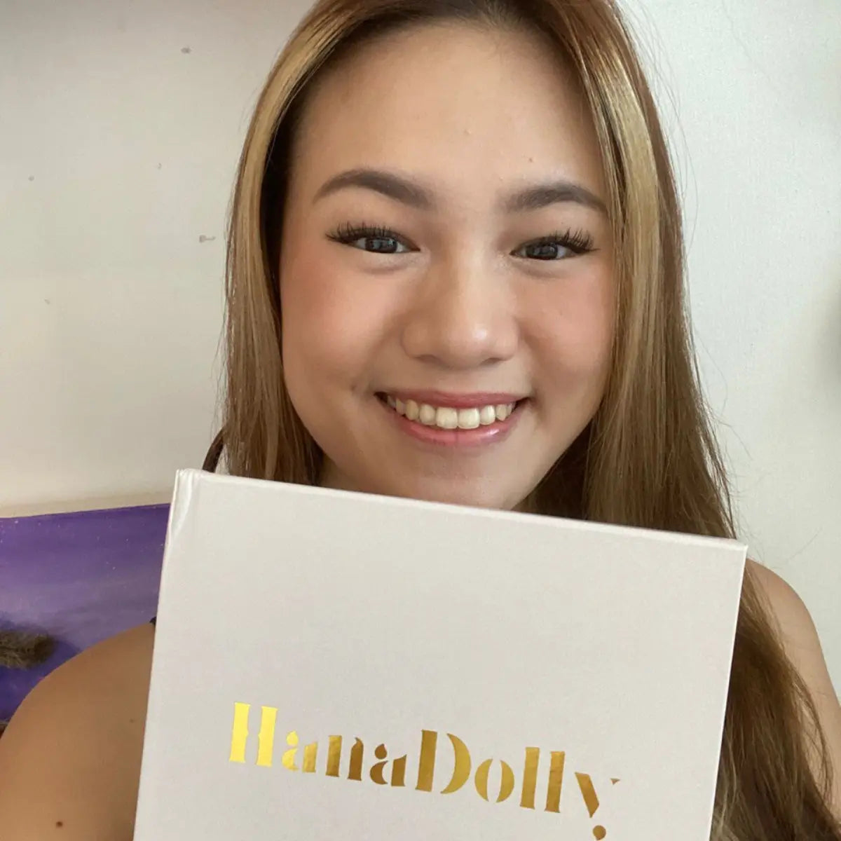 Smiling woman with HanaDolly DIY lash kit and soft natural lashes