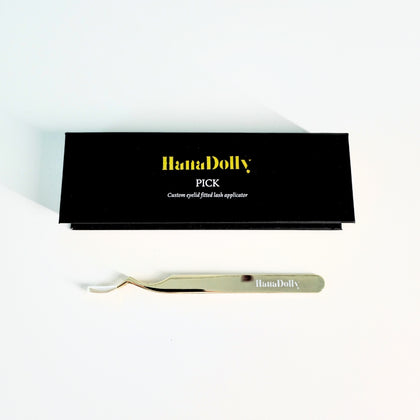 Flat lay photo of HanaDolly's PICK eyelash tweezer with and without box.
