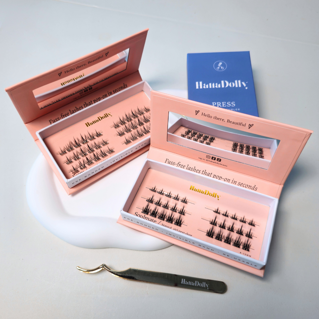 product shoot of press on lash bundle that includes two press on lash boxes, one eyelash tweezer and one eyelash curler by HanaDolly
