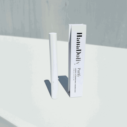 PURIFY eyelash cleansing solution by HanaDolly, designed to remove DIY lash glue and false lashes, with sleek packaging and product tube displayed against a minimalist background.