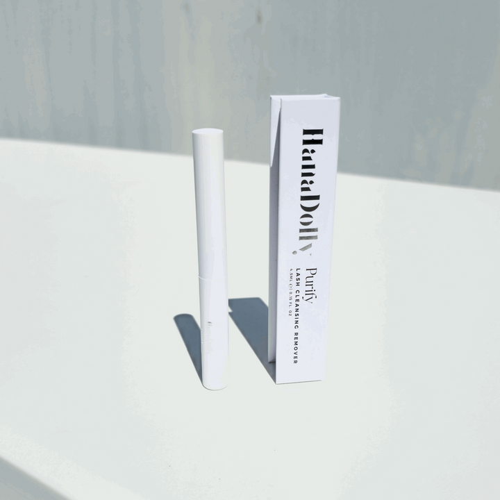 PURIFY eyelash cleansing solution by HanaDolly, designed to remove DIY lash glue and false lashes, with sleek packaging and product tube displayed against a minimalist background.