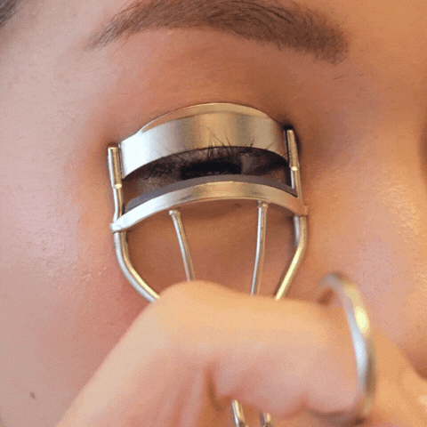 Curling natural lashes before applying DIY eyelash extensions at home