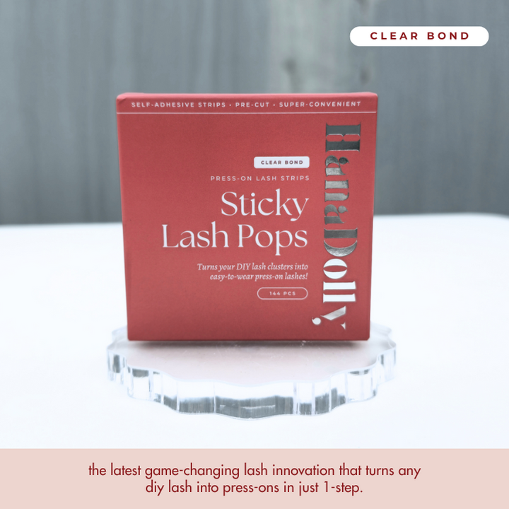 Close up product shot of HanaDolly lash adhesive strips with clear bond in red packaging box