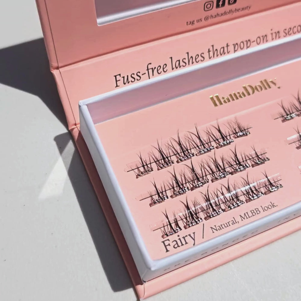 Close up video of HanaDolly's Fairy press-on lashes in their pink box packaging with the top opened and zoomed in on the rows of pre-glued lashes inside.