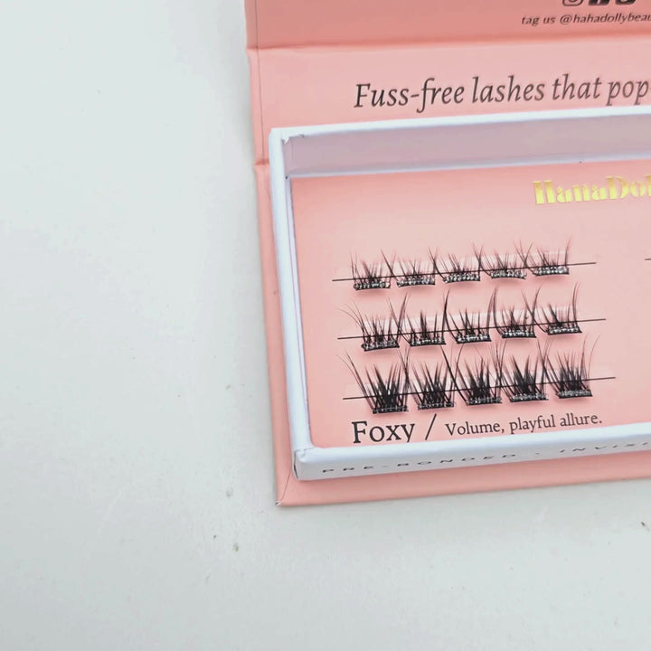 Video close up of Foxy Nimble press-on lash box, showcasing the full lash designs inside the box with it's criss-cross lash pattern